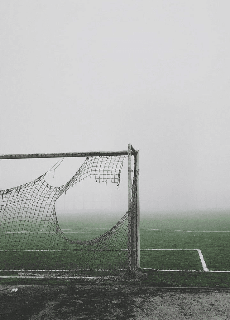 Football goal on a foggy field